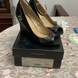 Never worn shiny black Ann Taylor wedges in original box.